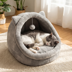 Cat sleeping inside cave bed